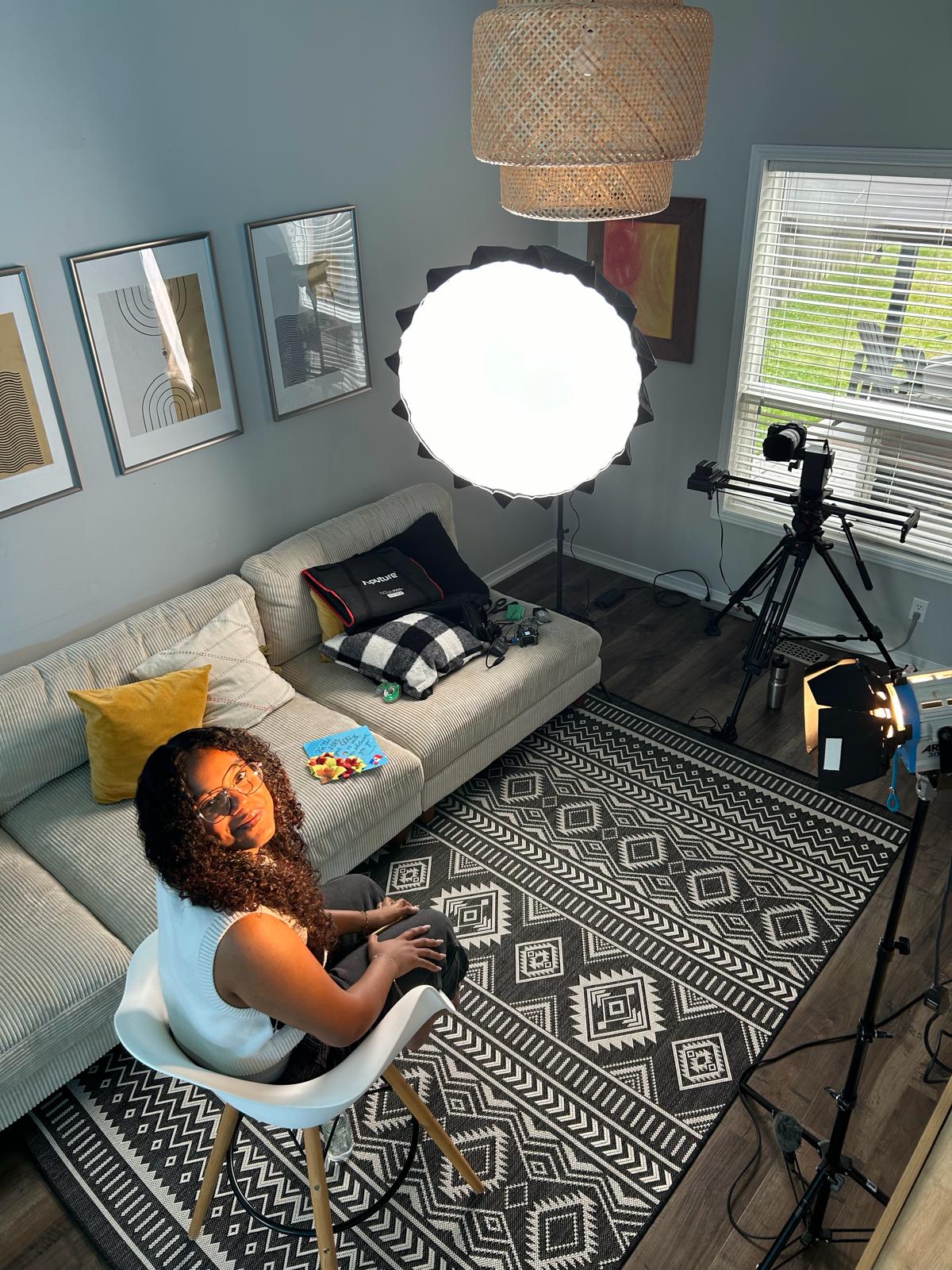 Behind the scenes of a video shoot — ring light, camera on a slider, Mia on a chair